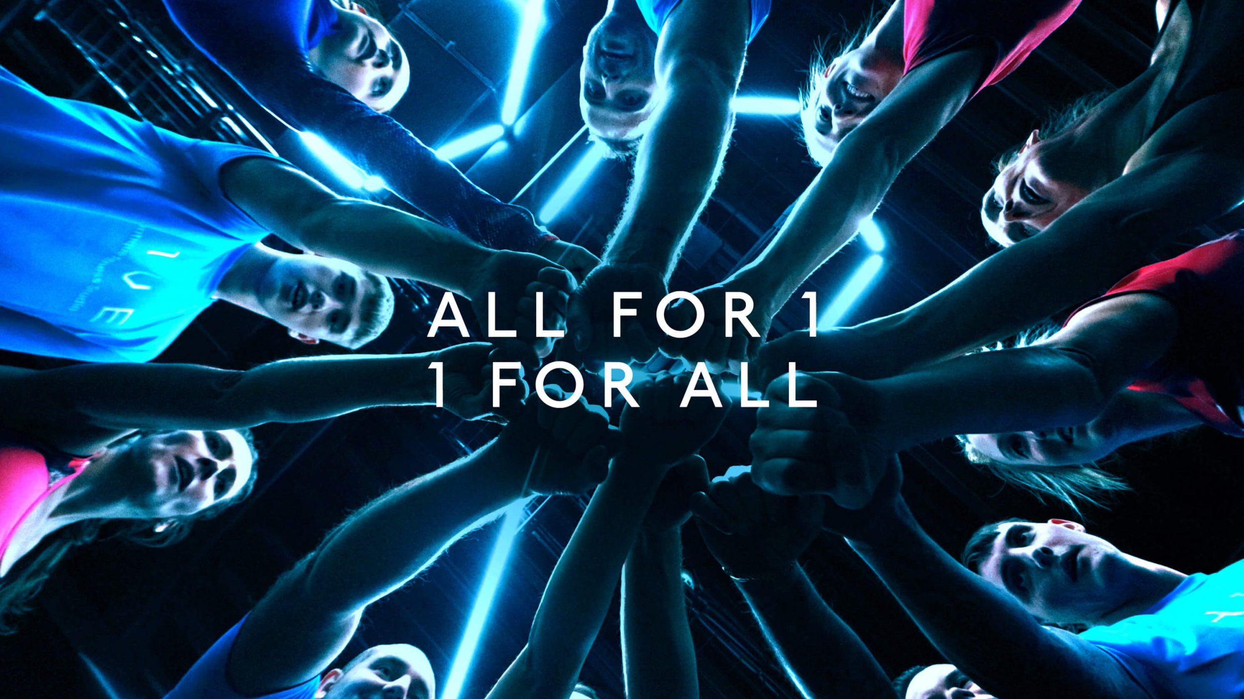 young white people in a circle, shot from below, all put their hands in to meet in the middle. text reads 'all for 1, 1 for all'