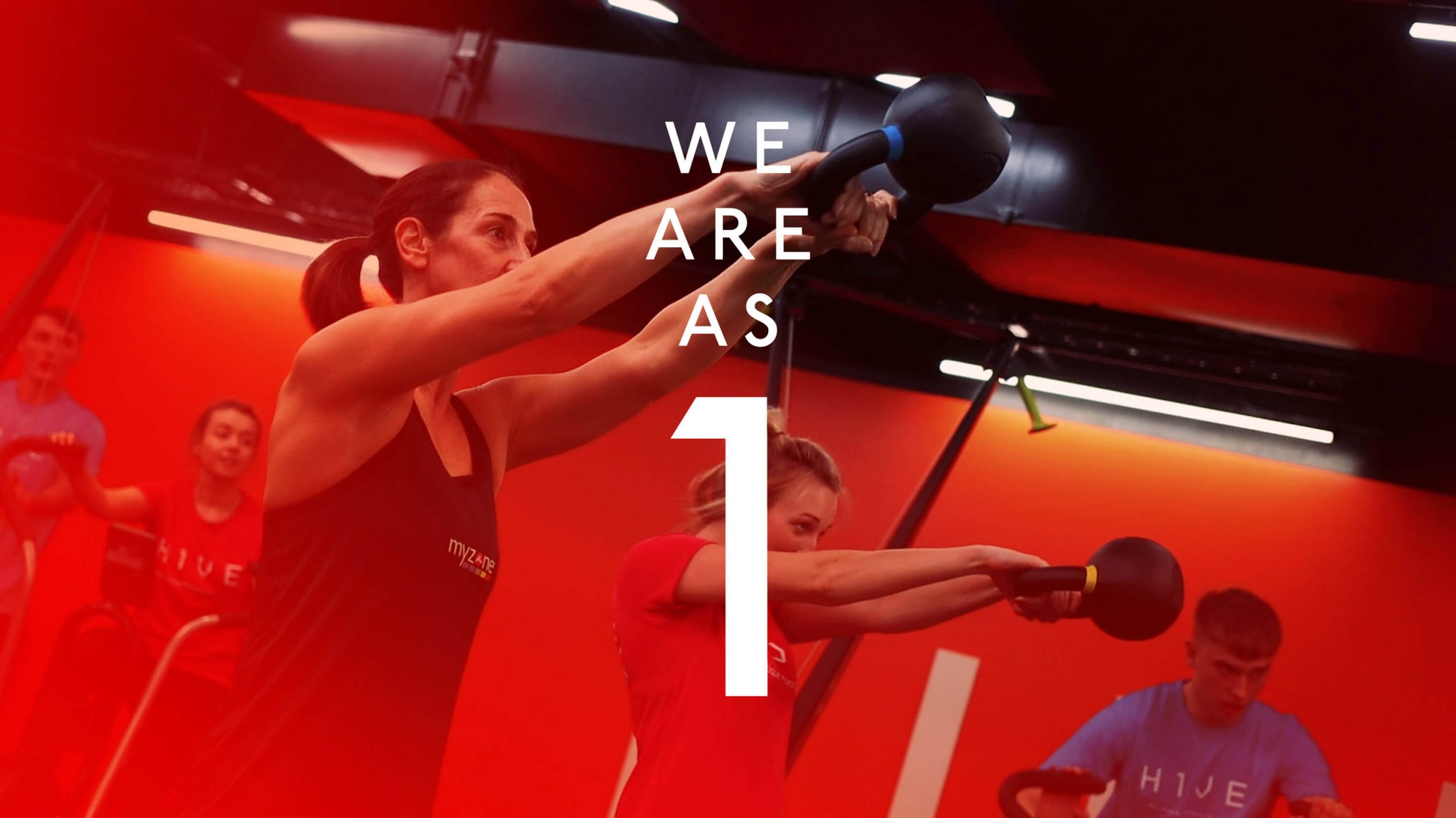 we are as 1 text overlayed onto a white brunette woman doing a kettlebell swing