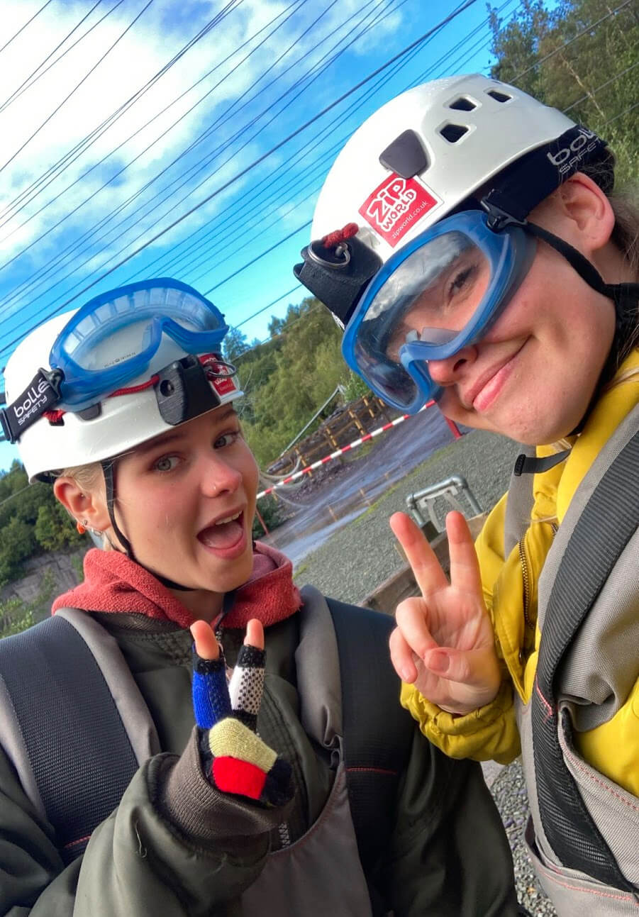 amy and her sister at zipworld with helmets and goggles on