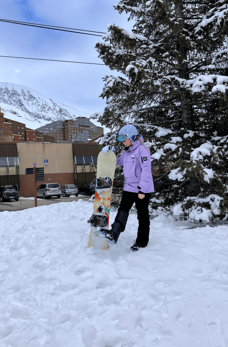 amy holding a snowboard. snowboarding on her horizon day when she was living in grenoble.